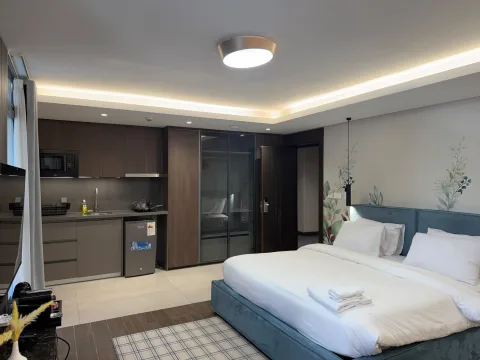 Studio 103 de The Stay : le lit et la kitchenette ouverte
